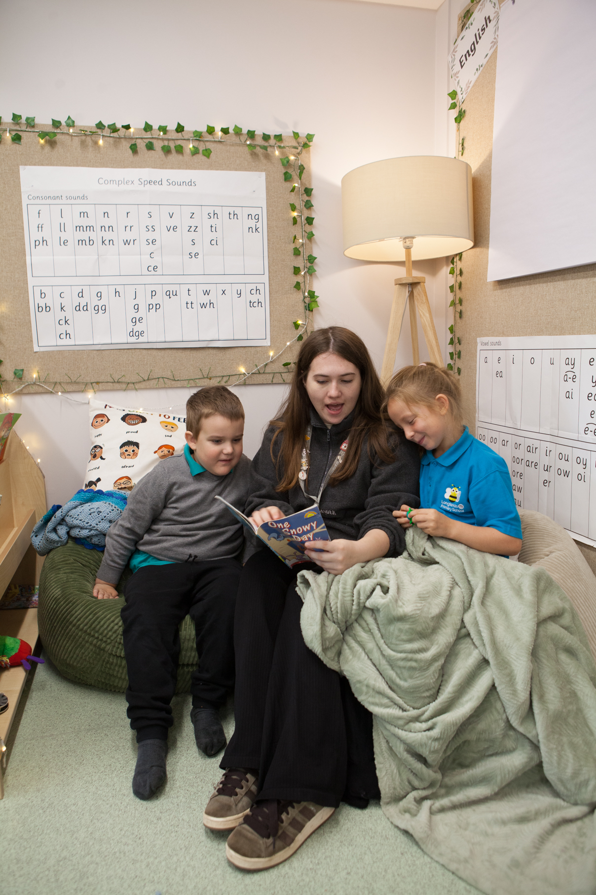 Pupils reading with a member of staff in The Meadow.